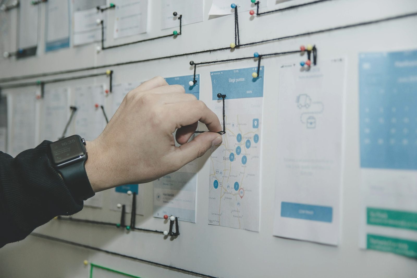 Hand placing a card on a delivery planning board