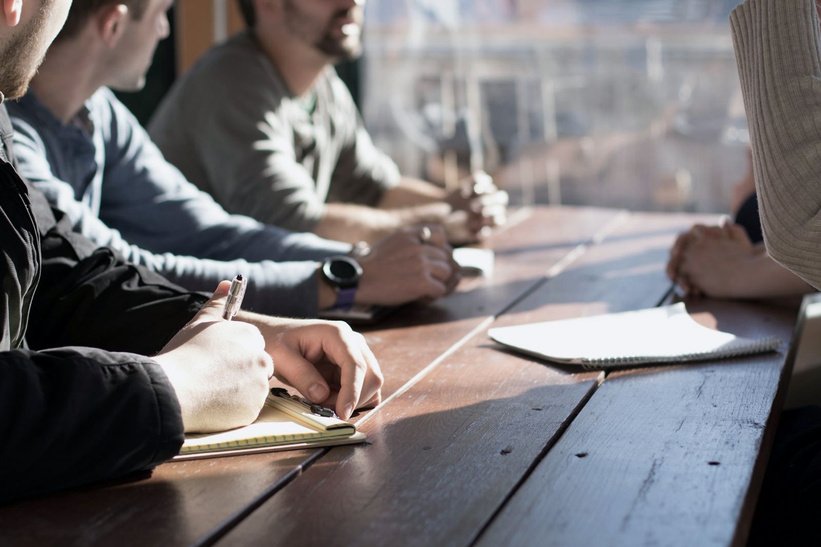 Client and supplier team members working together around a table